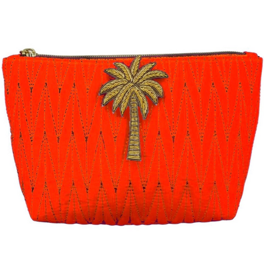 Orange Tribeca make up bag with a palm tree pin